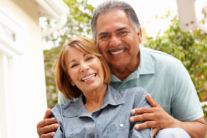 dental implant patients smiling and hugging