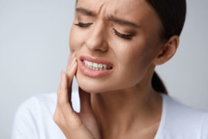 a dental patient in pain from wisdom teeth needing extraction